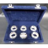 Boxed set of 6 'SILVER' napkin rings, foliate scroll embossed, weight 103g approx
