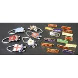 Collection of six enamel souvenir padlocks; together with enamel sports badges.
