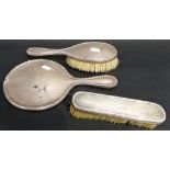 Pair of George V silver dressing table brushes, London 1915; together with a silver hand mirror (
