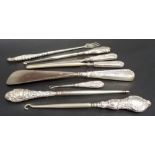 Collection of seven silver loaded handle dressing table implements; together with a silver handled