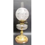 Victorian brass oil lamp, the ovoid etched foliate decorated shade over a wrythen fluted glass