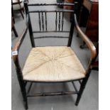 19th Century beech black painted faux bamboo elbow chair with rush seat.