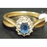 9ct gold diamond and sapphire cluster ring, the oval cut pale blue sapphire surrounded by small