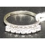 Contemporary 18k white gold seven stone diamond ring, each brilliant cut diamond of 0.10 spread