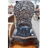 19th Century Anglo-Indian carved hardwood low chair, the spoon shaped back carved and pierced with