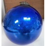 A blue glass witch ball, diameter 4'.