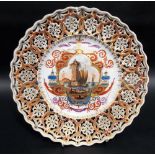 Meissen reticulated dish, the central lobed reserve painted with a harbour landscape with