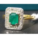 Attractive gold and platinum set emerald and diamond cluster ring, the central emerald cut stone