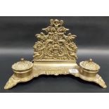 Victorian brass desk stand, the raised cast pierced letter rack decorated with Putti amongst