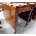 Victorian mahogany rectangular drop leaf dining table upon four turned supports with brass caps