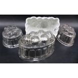 19th Century pearlware jelly mould with rose design together with three glass jelly moulds.