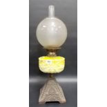 Victorian oil lamp with frosted ovoid shade over a yellow opaque pressed glass reservoir & on