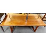 Large retro teak rectangular coffee table upon square plank supports, length 54.5'.