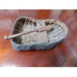 Interesting antique woven fabric covered Coracle with an oar, width 7'.