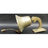 A brass external hanging bell with strike & bracket