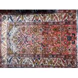 Persian Hamadan rug with foliate design on a pink ground with multiple boarders, 38' x 65'.