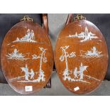 Pair of Chinese silver inlaid hardwood oval wall plaques, both decorated with figures in gardens,