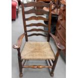 19th Century elm Lancashire ladder back elbow chair with rush covered seat, height 43.5'.