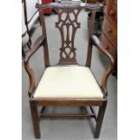 George III mahogany elbow chair with scroll carved and pierced splat and upholstered drop in seat.