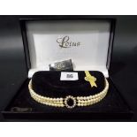 Lotus simulated pearl choker necklace with silver gilt central pendant.