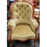 Victorian walnut framed button back chair with cabriole legs and castors.