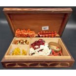 Teak box of beaded necklaces & bracelets inc. amber & coral