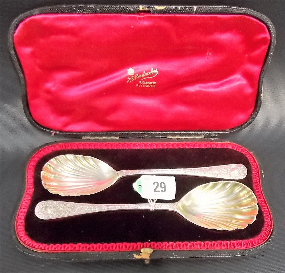 Victorian cased pair of silver shell bowl serving spoons with foliate scroll trellis decorated