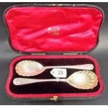 Victorian cased pair of silver shell bowl serving spoons with foliate scroll trellis decorated