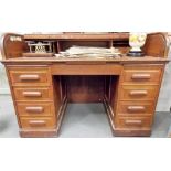 Early 20th Century oak tambour front roll top twin pedestal desk, the tambour front with fitted
