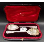 Victorian cased pair of silver shell bowl serving spoons with foliate scroll trellis decorated