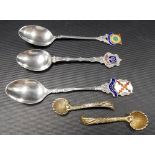 Three silver and enamel souvenir teaspoons 'St. Austell', 'St. Ives' and ' Falmouth'; together