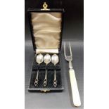 Set of three silver demi-tasse coffee spoons with pierced finials, cased; together with a