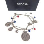 A vintage Chanel Ceinture silver belt / necklace, decorated with various medallions and blue and red