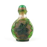 Chinese Peking glass snuff bottle, clear glass with green overlay of leaves and bats, 7.3cm