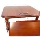 A good Victorian design mahogany wind out dining table, raised on heavy fluted baluster legs,