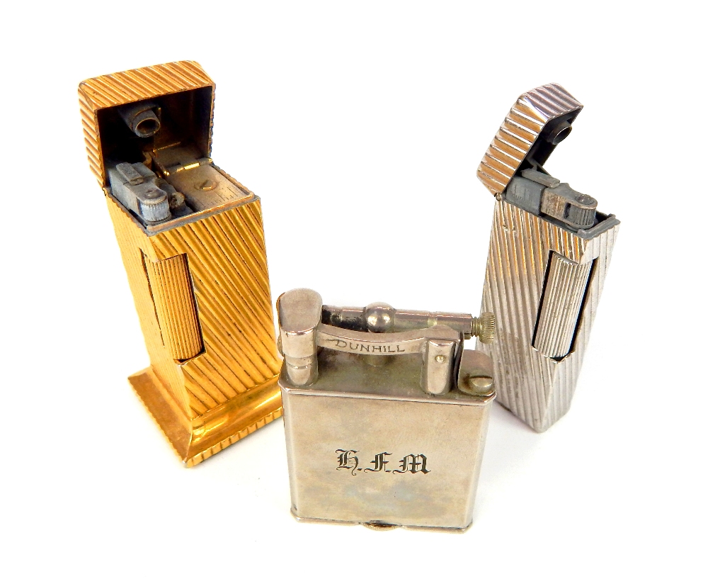 Three Dunhill lighters; gilded tower, 6.6cm, ribbed white metal, & lift arm (3) - Image 2 of 2