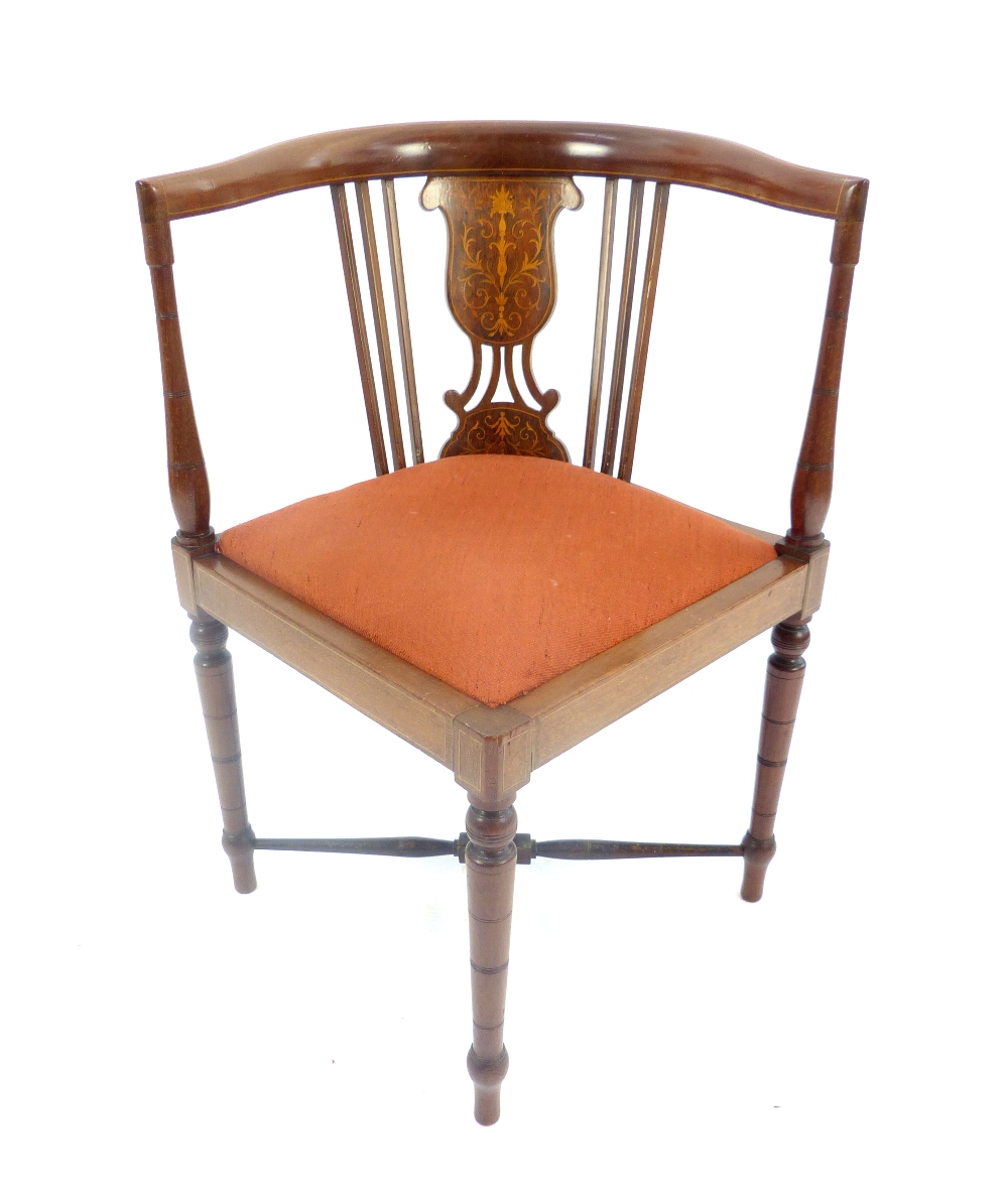 An Edwardian inlaid mahogany corner chair, raised on turned supports terminating in pad feet