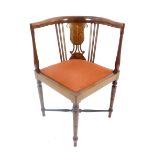 An Edwardian inlaid mahogany corner chair, raised on turned supports terminating in pad feet