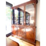 Early 20thC glazed bookcase in the manner of Gillows, dentil cornice, tri glazed doors with shield