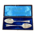 A pair of Georgian silver serving spoons with embo