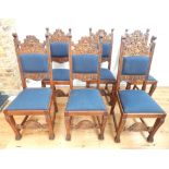 A set of six late C19th Flemish oak dining chairs, ornately carved