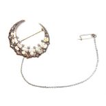 An antique gold, diamond and pearl stylised crescent brooch.