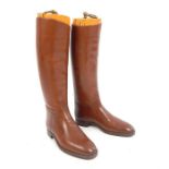 A pair of John Lobb Ltd calf length tan leather boots, complete with wooden trees