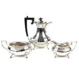 A George V silver matched three piece tea service, Birmingham 1913, comprising hot water pot, milk