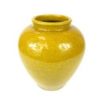 A Chinese crackle glaze monochrome pottery vase, ochre colour, ovoid shape, with glazed foot.