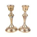 A pair of small silver candlesticks, W. I. Broadway & Co, Birmingham 1959, fluted baluster