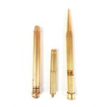 A hallmarked 9 ct yellow gold cigar piercer with 2 x gold-filled propelling pencils