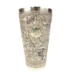 A 19th century probably Indian silver beaker, embossed with village scene, bearing blank