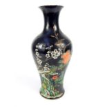 A Chinese porcelain famille noire baluster vase, enamelled with foliate decoration, bearing six