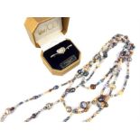 A long freshwater pearl necklace containing a number of colours, shapes and sizes of pearls